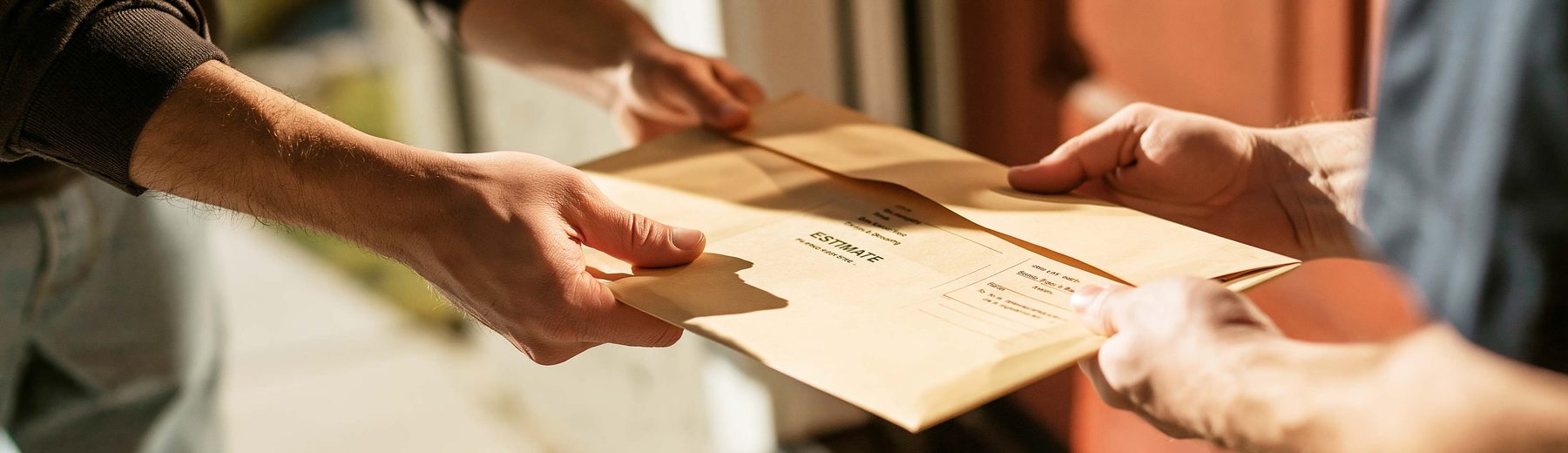 an estimate folder handed across a front-door threshold