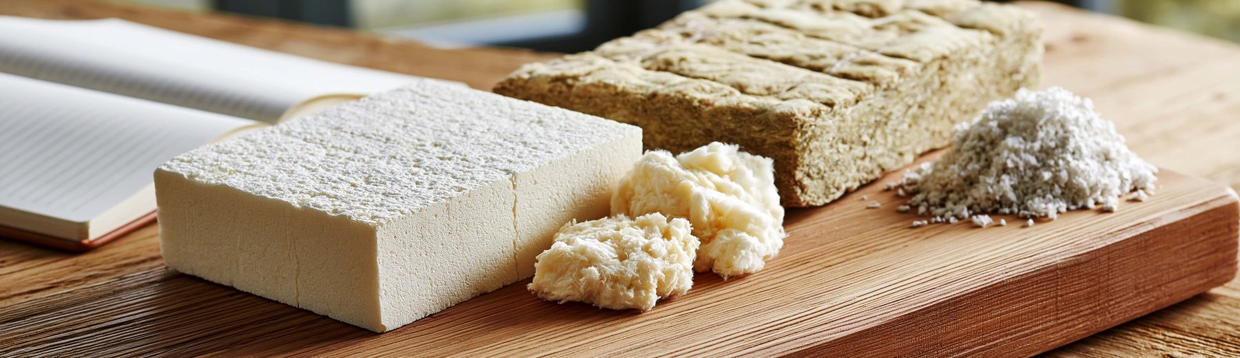 rigid foam, fiberglass batt, and loose cellulose samples on a workbench