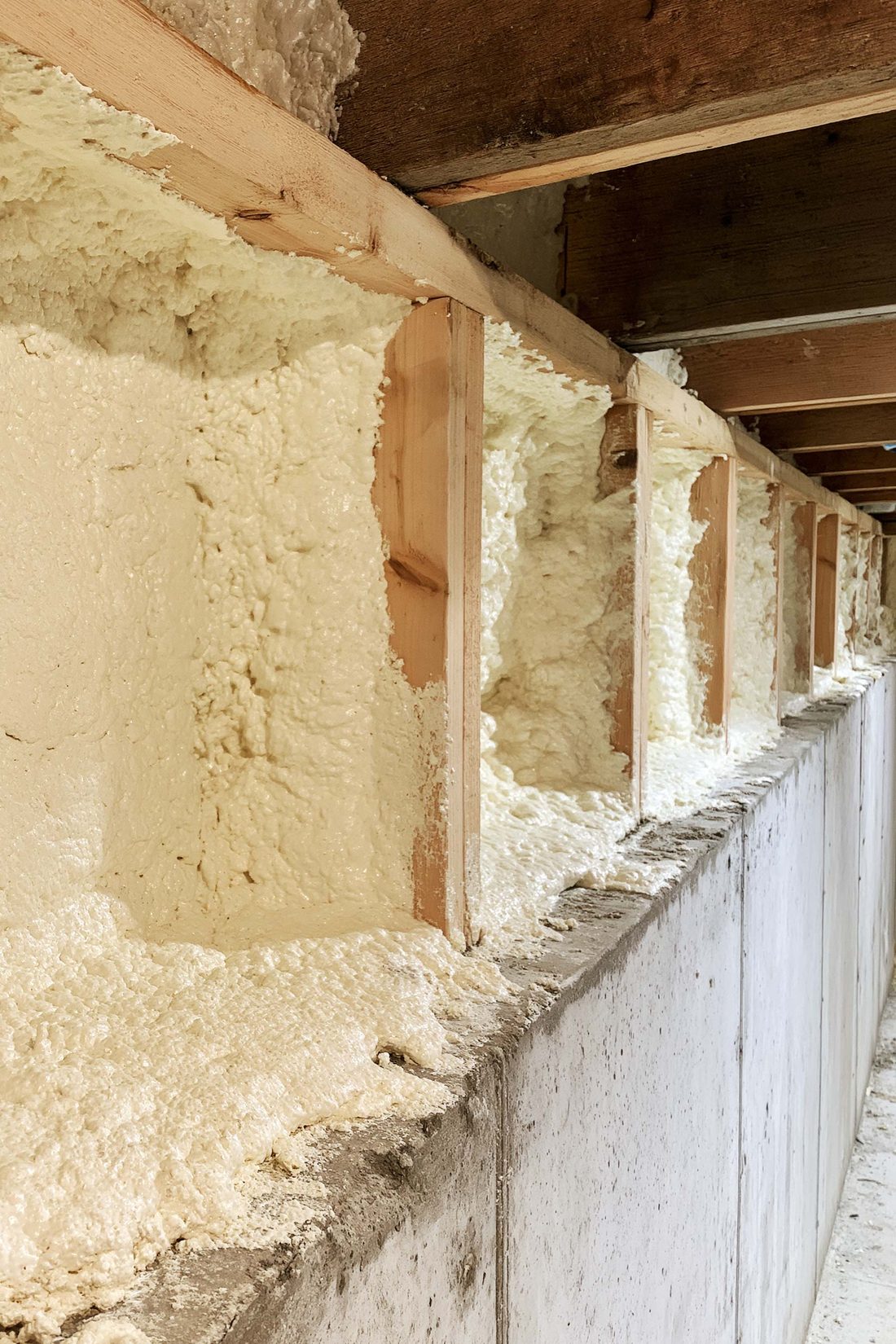Foam-filled rim joist bays running along a foundation wall